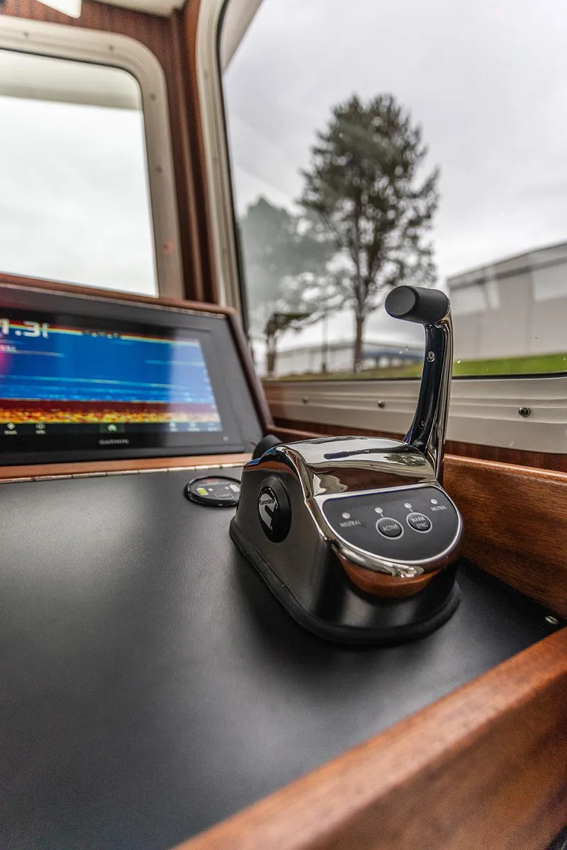 Slide: The Image of American Tug 395 helm controls, 2026 model, featuring modern navigation technology. - 8