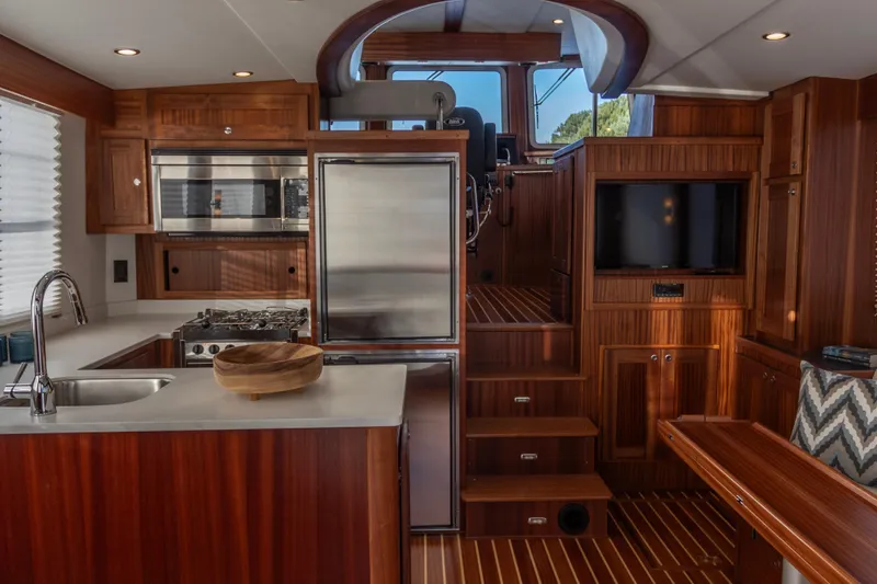 Slide: The Image of Luxurious interior of 2026 American Tug 435 with modern kitchen and wooden finishes. - 10