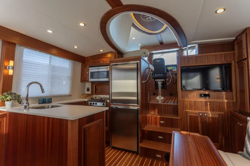 Slide: The Image of Luxurious interior of 2026 American Tug 435 with modern kitchen and wood finishes. - 11