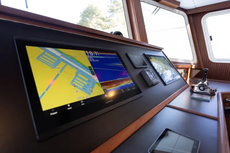 Slide: The Image of 2026 American Tug 435 helm with advanced navigation displays and controls. - 14