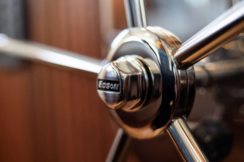 Slide: The Image of Close-up of a polished metal steering wheel on a 2026 American Tug 435 boat. - 16