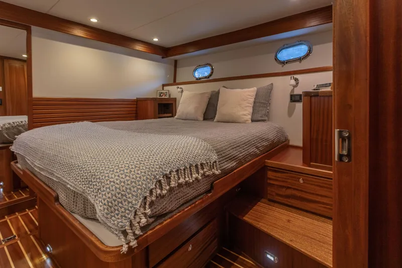 Slide: The Image of Luxurious cabin interior of 2026 American Tug 435 with cozy bed and wooden accents. - 21