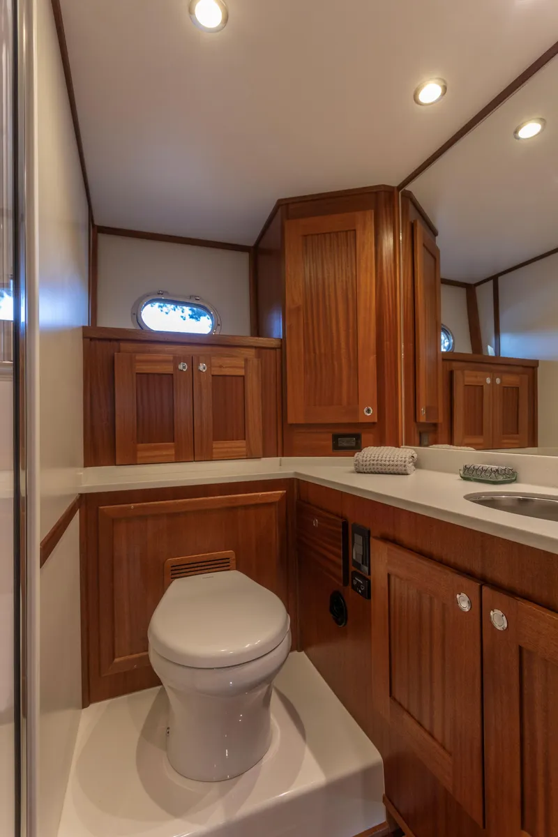 Slide: The Image of Luxurious bathroom in 2026 American Tug 435 yacht with wooden cabinetry and modern fixtures. - 23