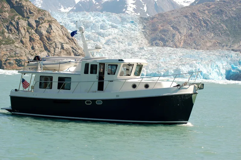Slide: The Image of American Tug 435 (2025) cruising near a glacier in scenic waters. - 27