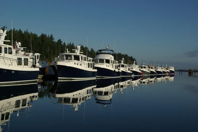 Slide: The Image of Line of American Tug 435 boats docked on calm water, 2025 model. - 28