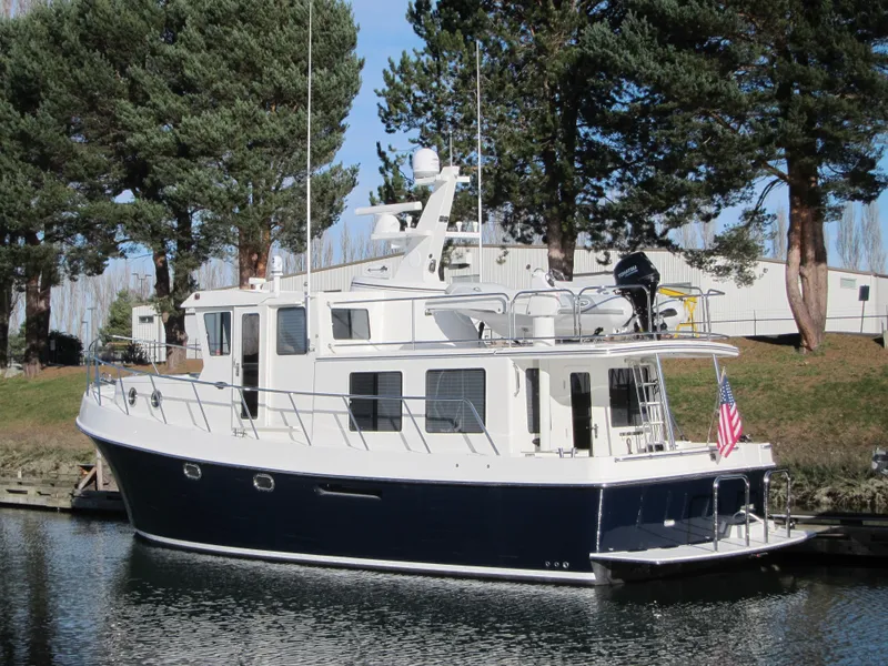 Slide: The Image of 2025 American Tug 435 docked near trees and buildings. - 43