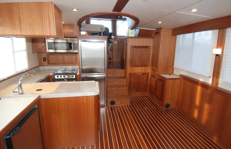 Slide: The Image of Modern kitchen interior of 2025 American Tug 435 with wood finishes and stainless steel appliances. - 47
