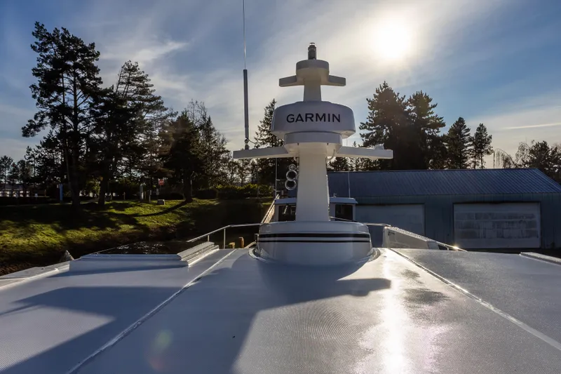 Slide: The Image of American Tug 435 (2026) with Garmin equipment, docked under a bright sunlit sky. - 6