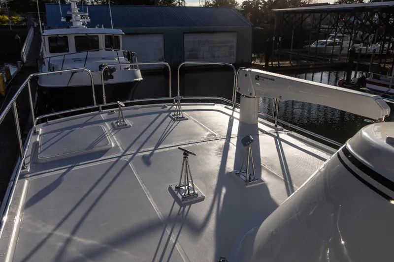 Slide: The Image of American Tug 435, 2026 model, docked with visible deck and railing. - 7