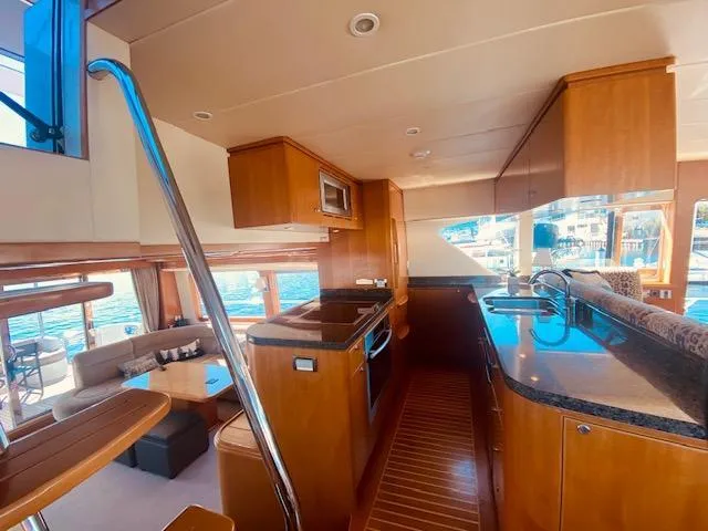 Slide: The Image of Interior of 2007 Regency Yachts 670 Pilothouse, featuring modern kitchen and spacious living area. - 10
