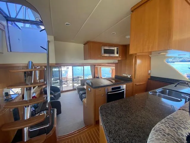 Slide: The Image of Luxurious interior of 2007 Regency Yachts 670 Pilothouse with modern kitchen and seating area. - 11