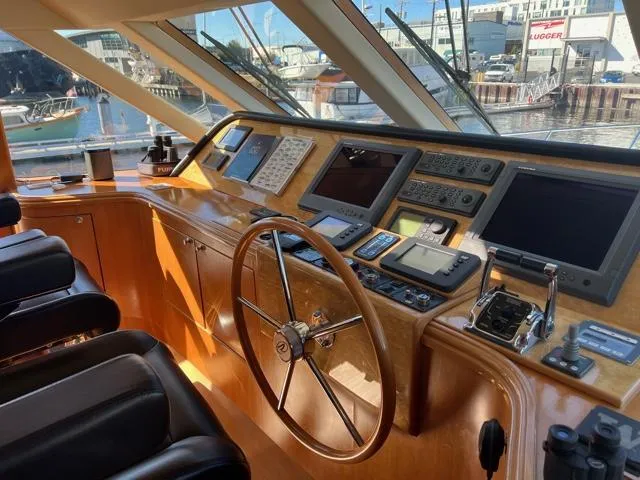 Slide: The Image of 2007 Regency Yachts 670 Pilothouse helm with navigation equipment and waterfront view. - 16
