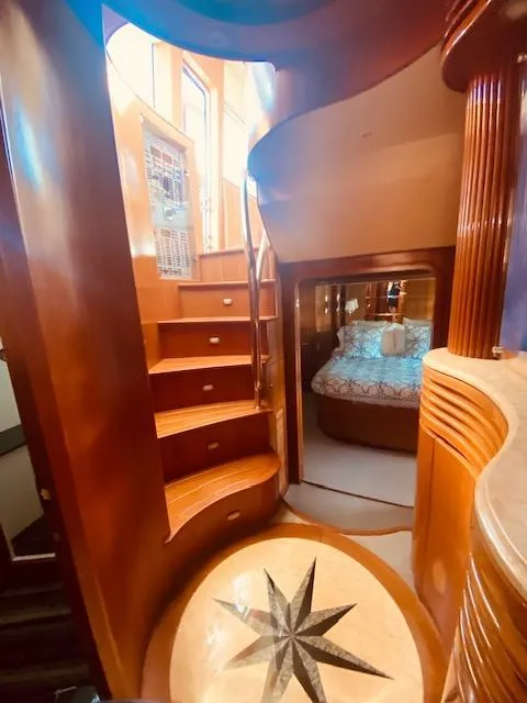 Slide: The Image of Luxurious interior of 2007 Regency Yachts 670 Pilothouse with wooden staircase and cozy bedroom. - 18