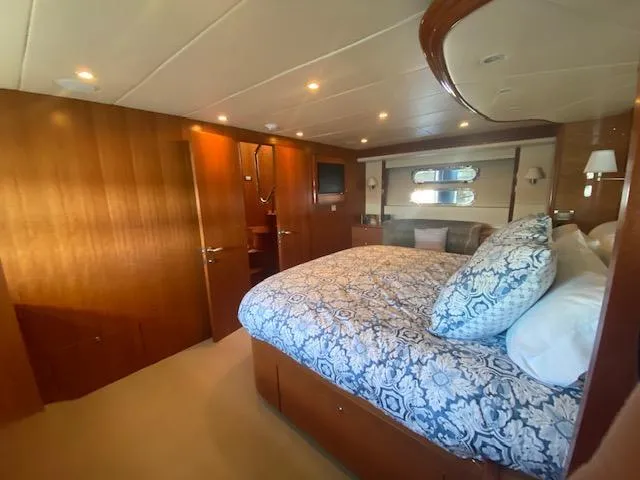 Slide: The Image of Luxurious bedroom interior of 2007 Regency Yachts 670 Pilothouse with wood paneling and cozy bedding. - 23
