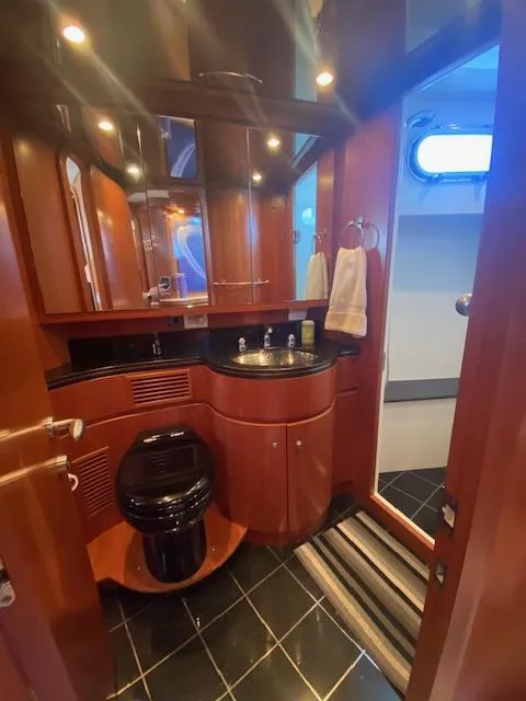 Slide: The Image of Luxurious bathroom in a 2007 Regency Yachts 670 Pilothouse with wood cabinetry and modern fixtures. - 25
