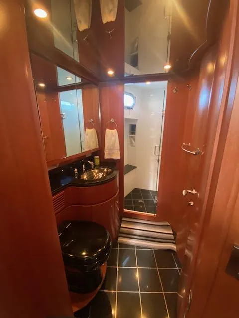 Slide: The Image of Luxurious bathroom in a 2007 Regency Yachts 670 Pilothouse with elegant wood finishes. - 26