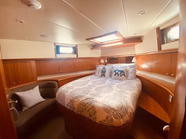 Slide: The Image of Luxurious bedroom in 2007 Regency Yachts 670 Pilothouse with elegant wood paneling. - 28