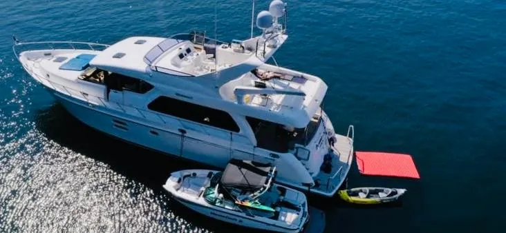 Slide: The Image of Aerial view of 2007 Regency Yachts 670 Pilothouse on water with boats and kayak. - 3