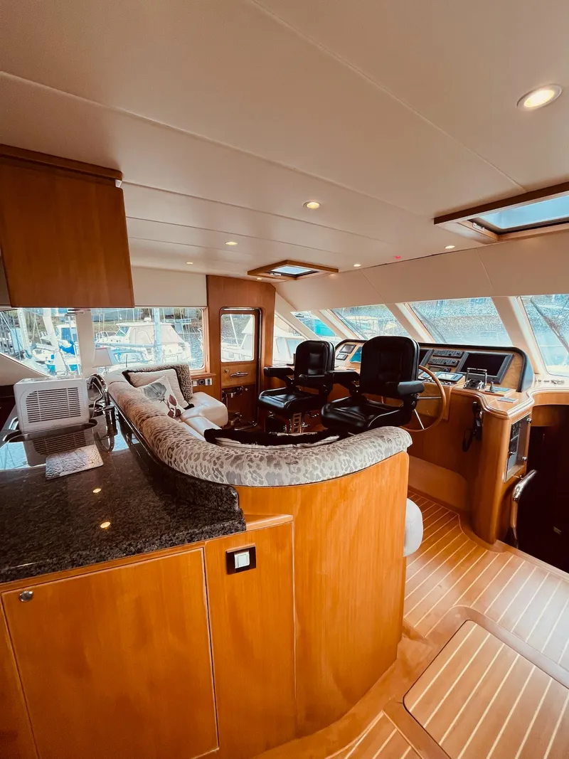 Slide: The Image of Luxurious 2007 Regency Yachts 670 Pilothouse interior with elegant wood finishes and modern helm. - 30
