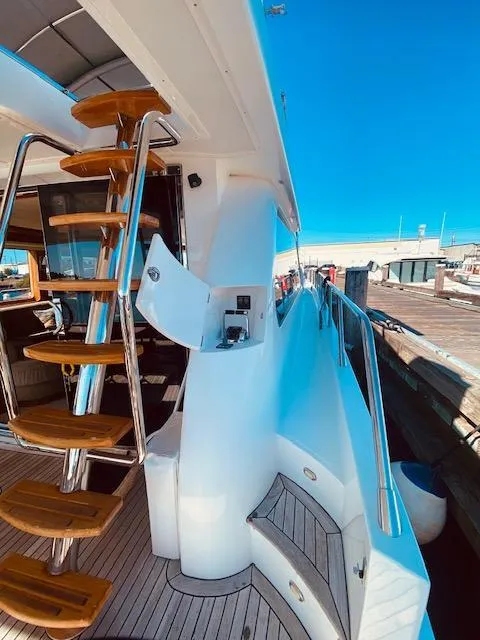 Slide: The Image of 2007 Regency Yachts 670 Pilothouse, exterior view with wooden steps and dock. - 37