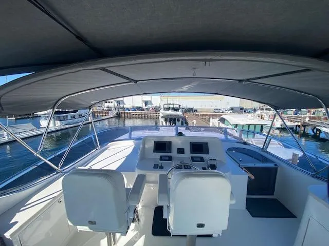 Slide: The Image of 2007 Regency Yachts 670 Pilothouse helm station with dual seats and navigation equipment. - 39