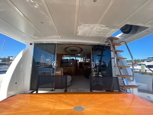 Slide: The Image of 2007 Regency Yachts 670 Pilothouse aft deck with table and stairs. - 4
