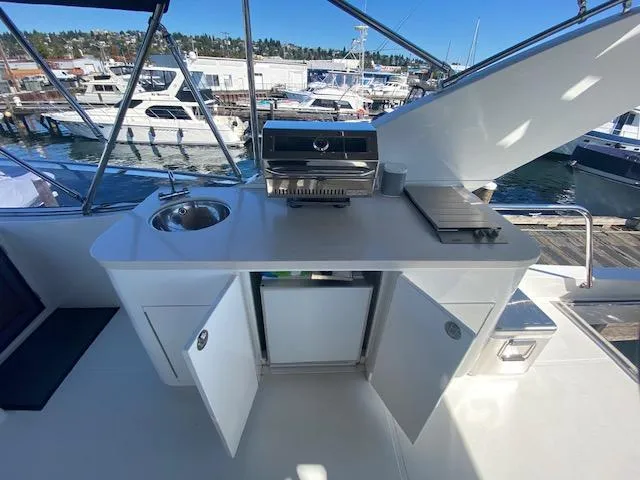 Slide: The Image of Outdoor kitchen on 2007 Regency Yachts 670 Pilothouse with sink, grill, and storage. - 40