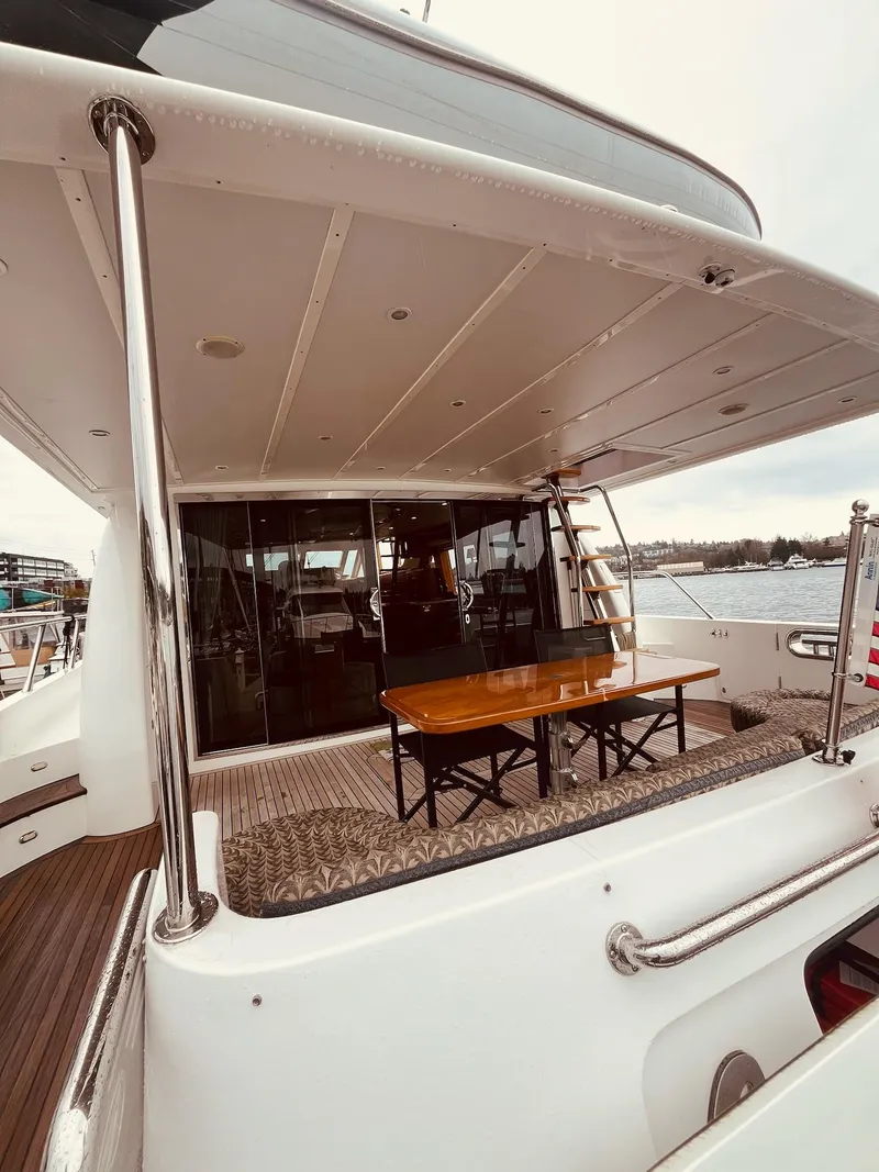 Slide: The Image of 2007 Regency Yachts 670 Pilothouse, spacious deck with table, docked at marina. - 44