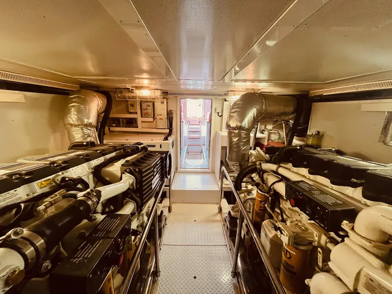 Slide: The Image of Engine room of 2007 Regency Yachts 670 Pilothouse, featuring dual engines and control systems. - 46