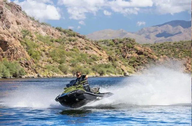 Slide: The Image of 2024 Kawasaki Waverunner JET SKI® ULTRA® 310LX speeding on a scenic lake. - 4