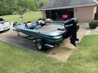 Slide: The Image of 2006 Nitro 901 CDX DC boat with Mercury engine parked on driveway. - 5