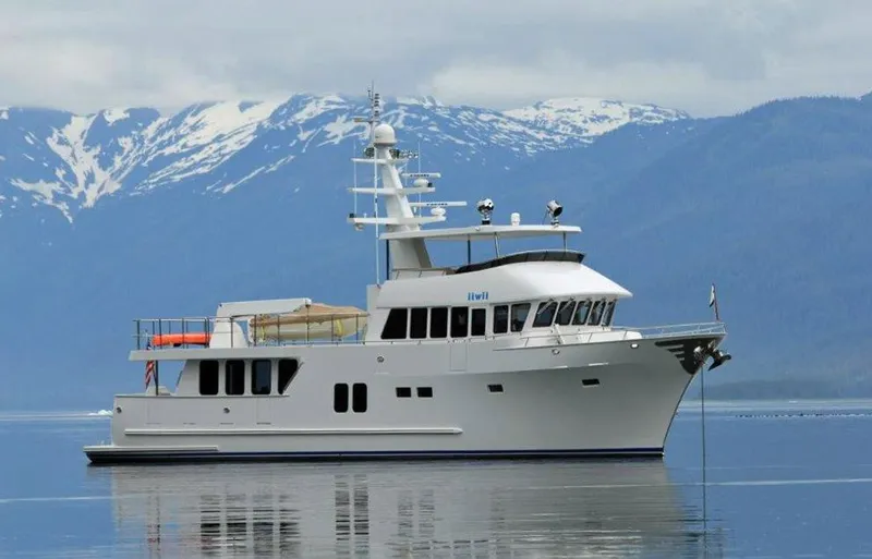 Slide: The Image of 2017 Northern Marine Expedition yacht on calm water with snowy mountains in the background. - 11