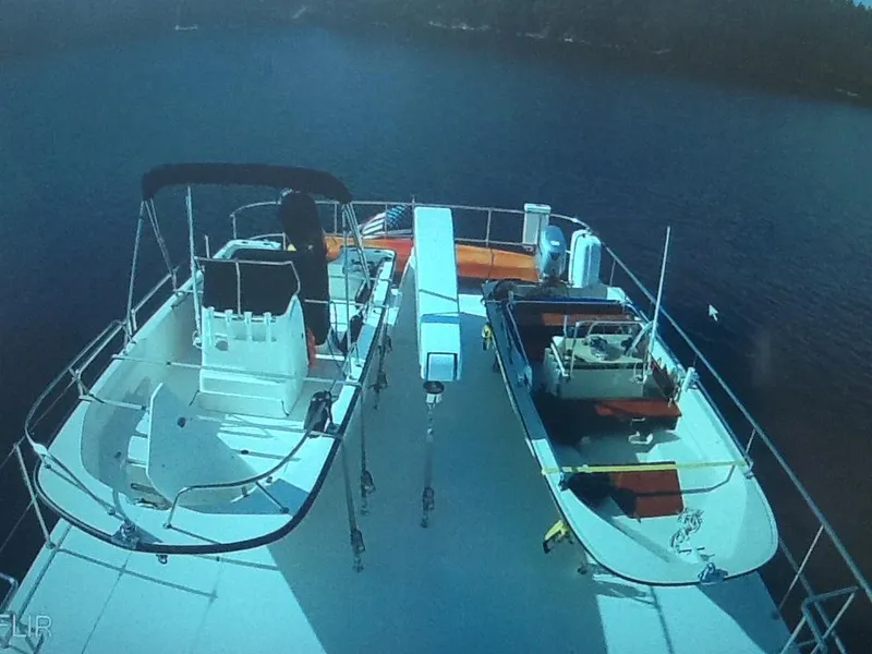 Slide: The Image of 2017 Northern Marine Expedition yacht deck with boats and equipment on calm water. - 17