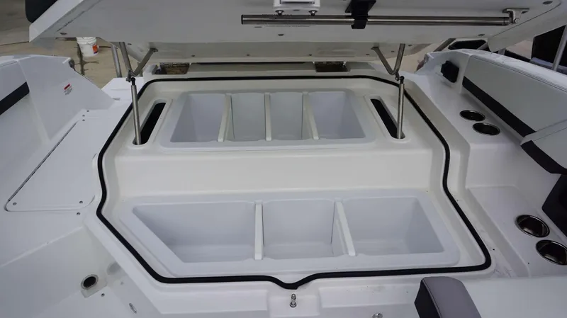 Slide: The Image of 2024 Cobalt R4 boat with open storage compartments and cup holders. - 10