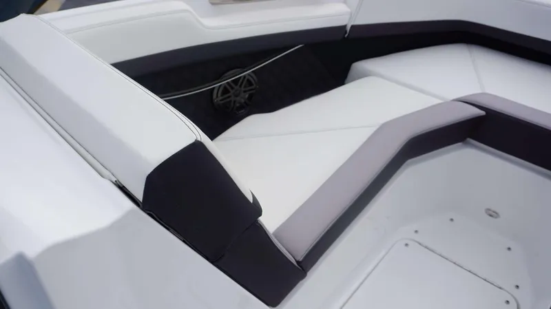 Slide: The Image of 2024 Cobalt R4 boat interior seating with white and black upholstery. - 14