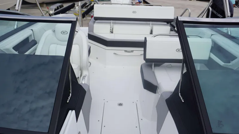 Slide: The Image of 2024 Cobalt R4 boat interior with white and gray seating, windshield, and storage compartments. - 15
