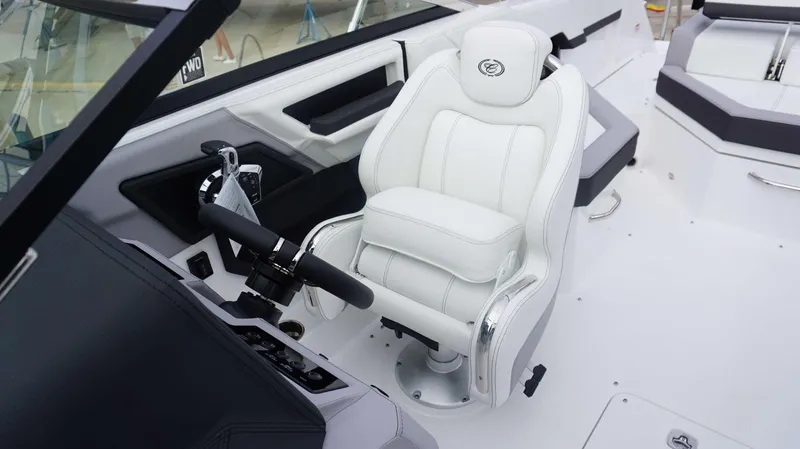 Slide: The Image of 2024 Cobalt R4 boat interior with white captain's chair and control panel. - 17