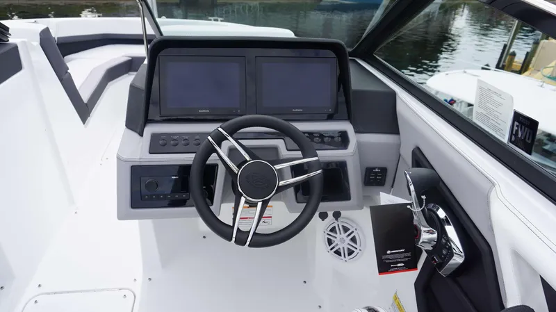 Slide: The Image of 2024 Cobalt R4 boat dashboard with dual Garmin screens and modern steering wheel. - 4
