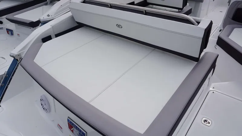 Slide: The Image of 2024 Cobalt R4 boat interior with white and gray seating and sun pad. - 6