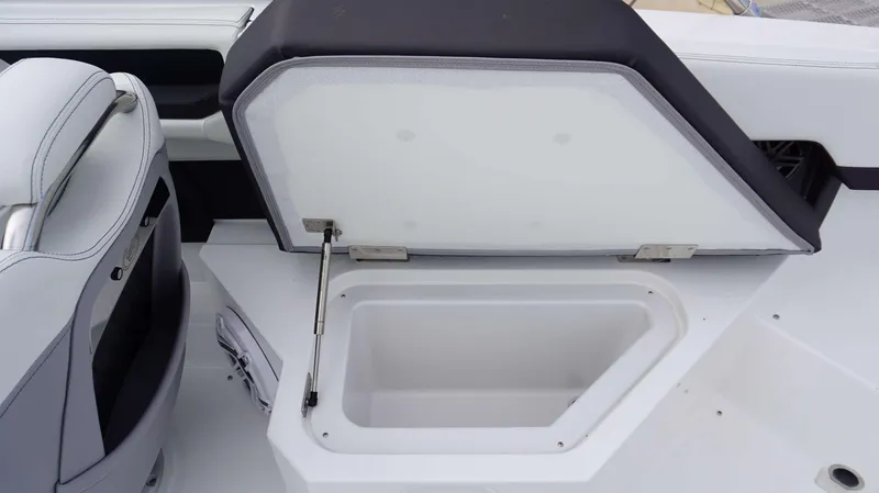 Slide: The Image of 2024 Cobalt R4 boat storage compartment with open lid. - 7