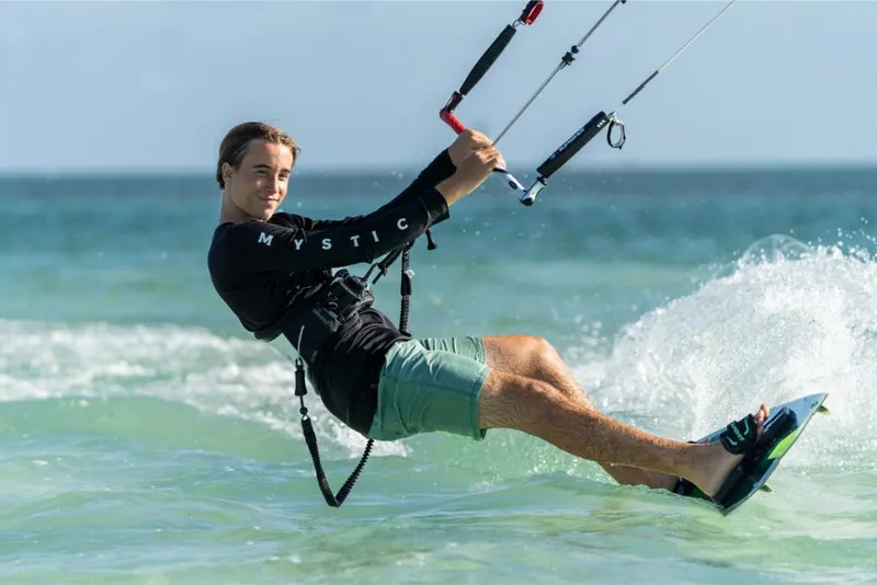 Slide: The Image of Man kiteboarding on the ocean, enjoying water sports adventure. - 19