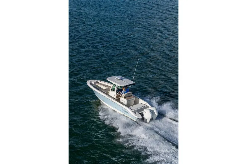 Slide: The Image of 2024 Boston Whaler 280 Dauntless boat cruising on open water. - 47
