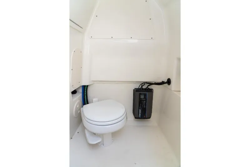 Slide: The Image of 2024 Boston Whaler 280 Dauntless boat interior bathroom with toilet and equipment. - 49