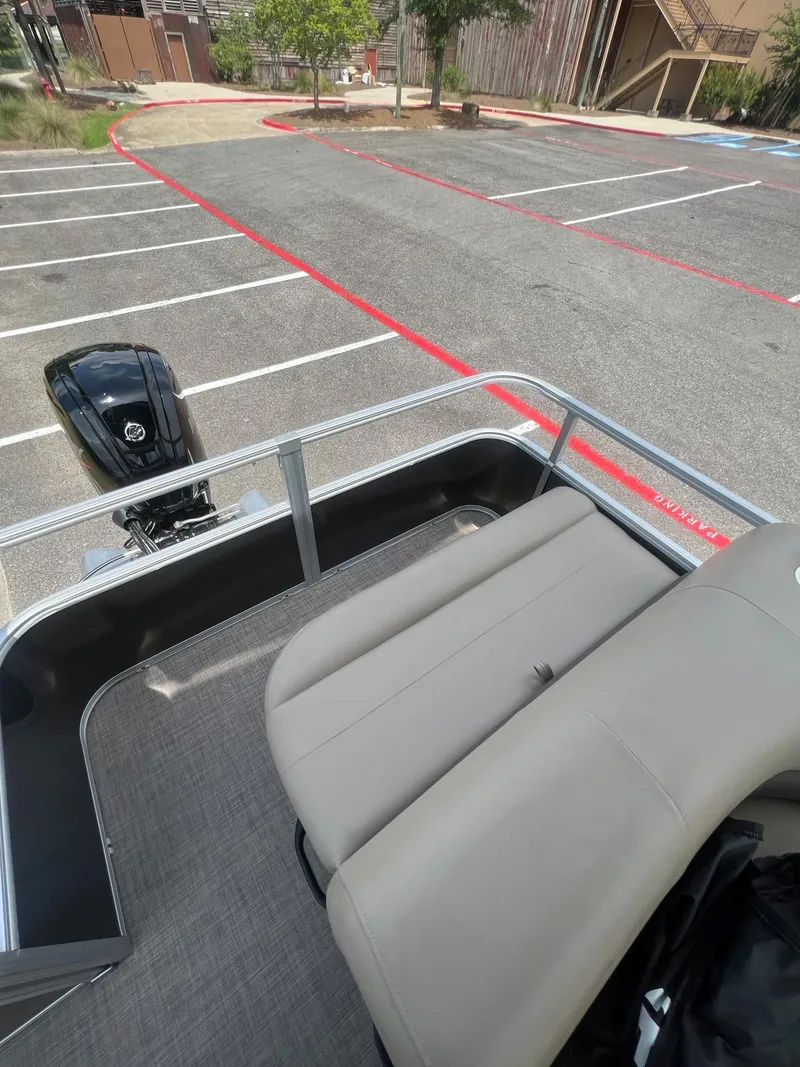 Slide: The Image of 2024 Sun Tracker Party Barge 18 DLX pontoon boat in parking lot. - 16