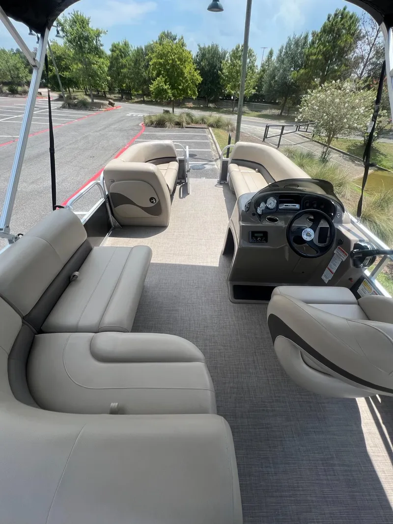 Slide: The Image of 2024 Sun Tracker Party Barge 18 DLX interior with seating and steering console. - 17