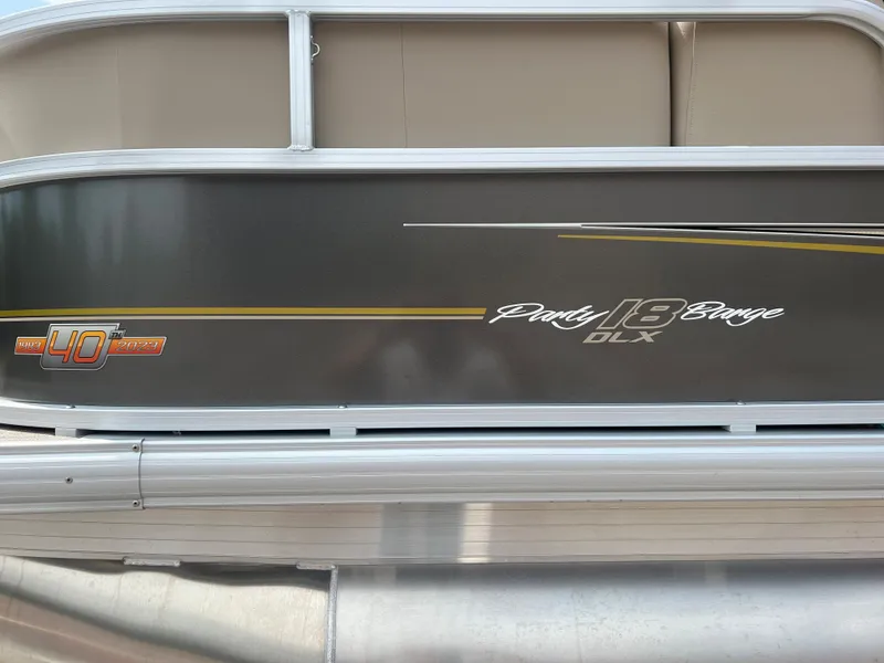 Slide: The Image of 2024 Sun Tracker Party Barge 18 DLX pontoon boat side view. - 18