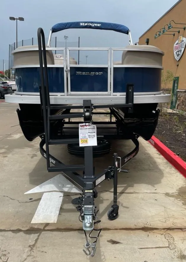 Slide: The Image of 2024 Ranger Reata 200C pontoon boat on trailer in parking lot. - 1