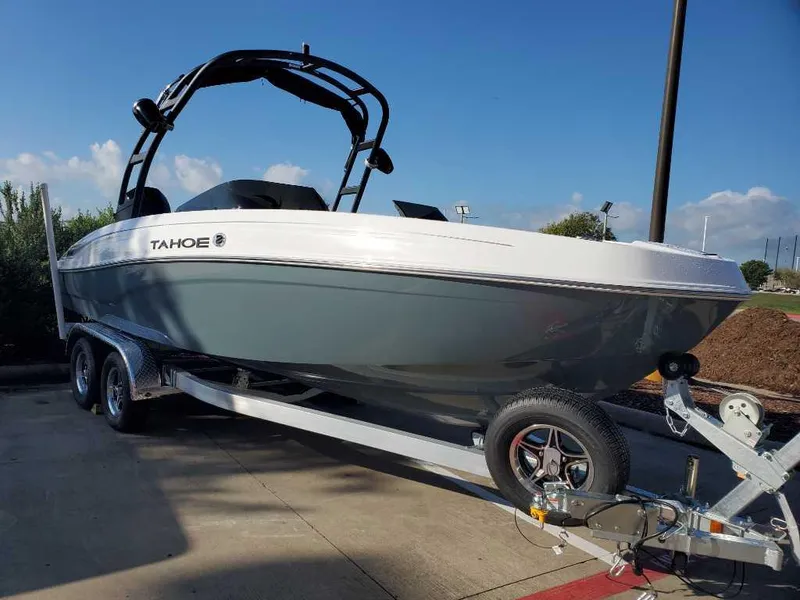 Slide: The Image of 2024 Tahoe T21 boat on a trailer in a parking lot. - 0