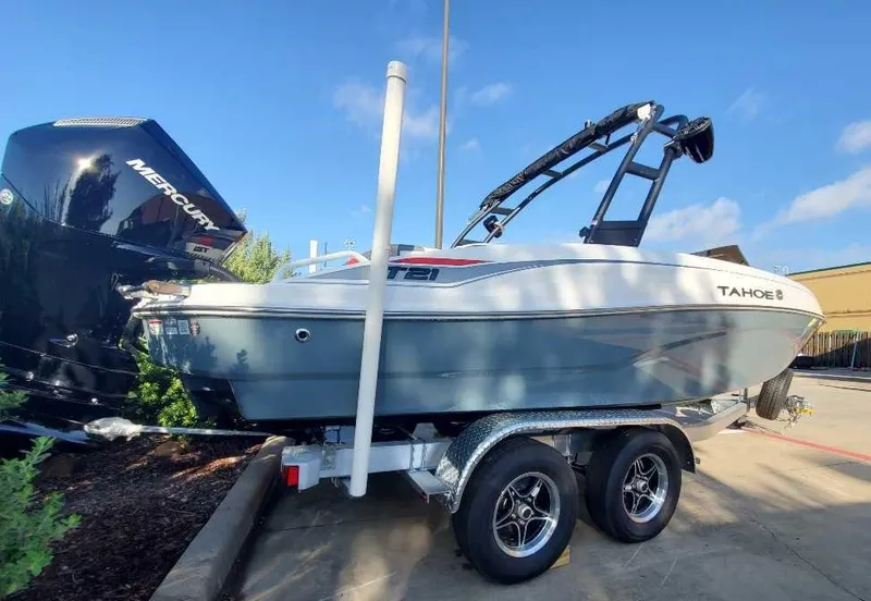 Slide: The Image of 2024 Tahoe T21 boat on a trailer with a Mercury outboard motor. - 1