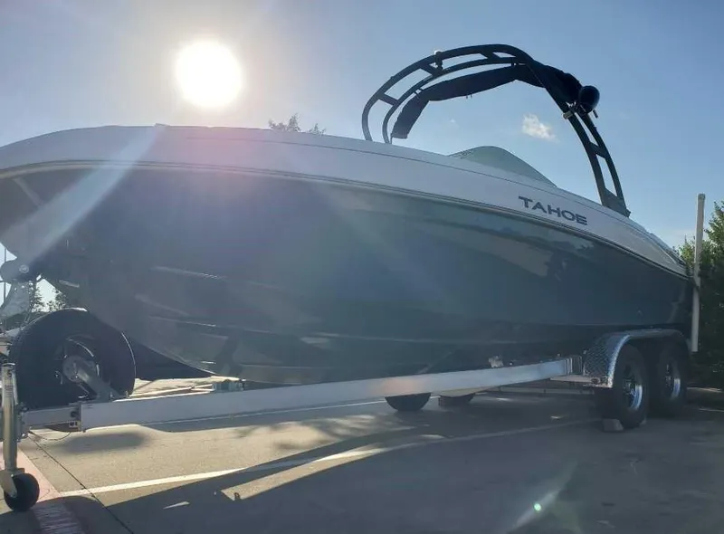 Slide: The Image of 2024 Tahoe T21 boat on trailer in sunlight. - 2